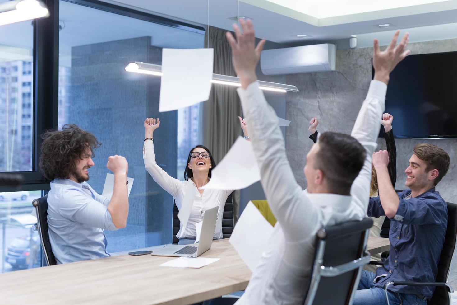 startup Group of young business people throwing documents photo
