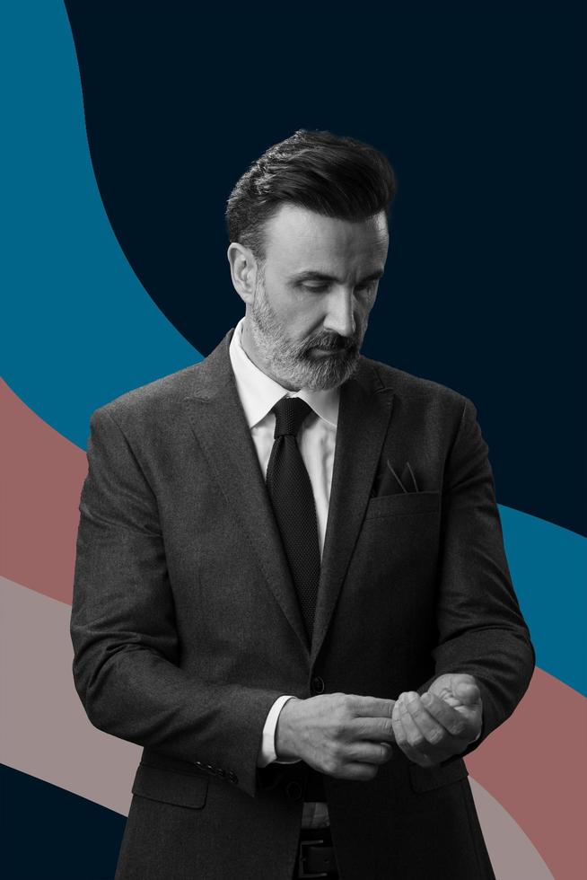 retrato en blanco y negro de un elegante y elegante hombre de negocios con barba y ropa informal de negocios contra un fondo de diseño retro colorido que gesticula con las manos foto