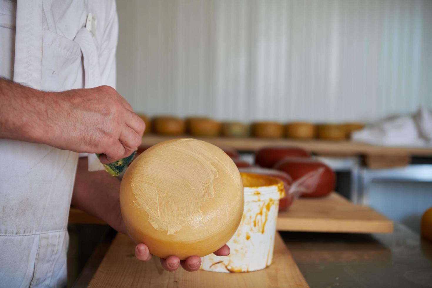 Cheese maker at local  production factory photo