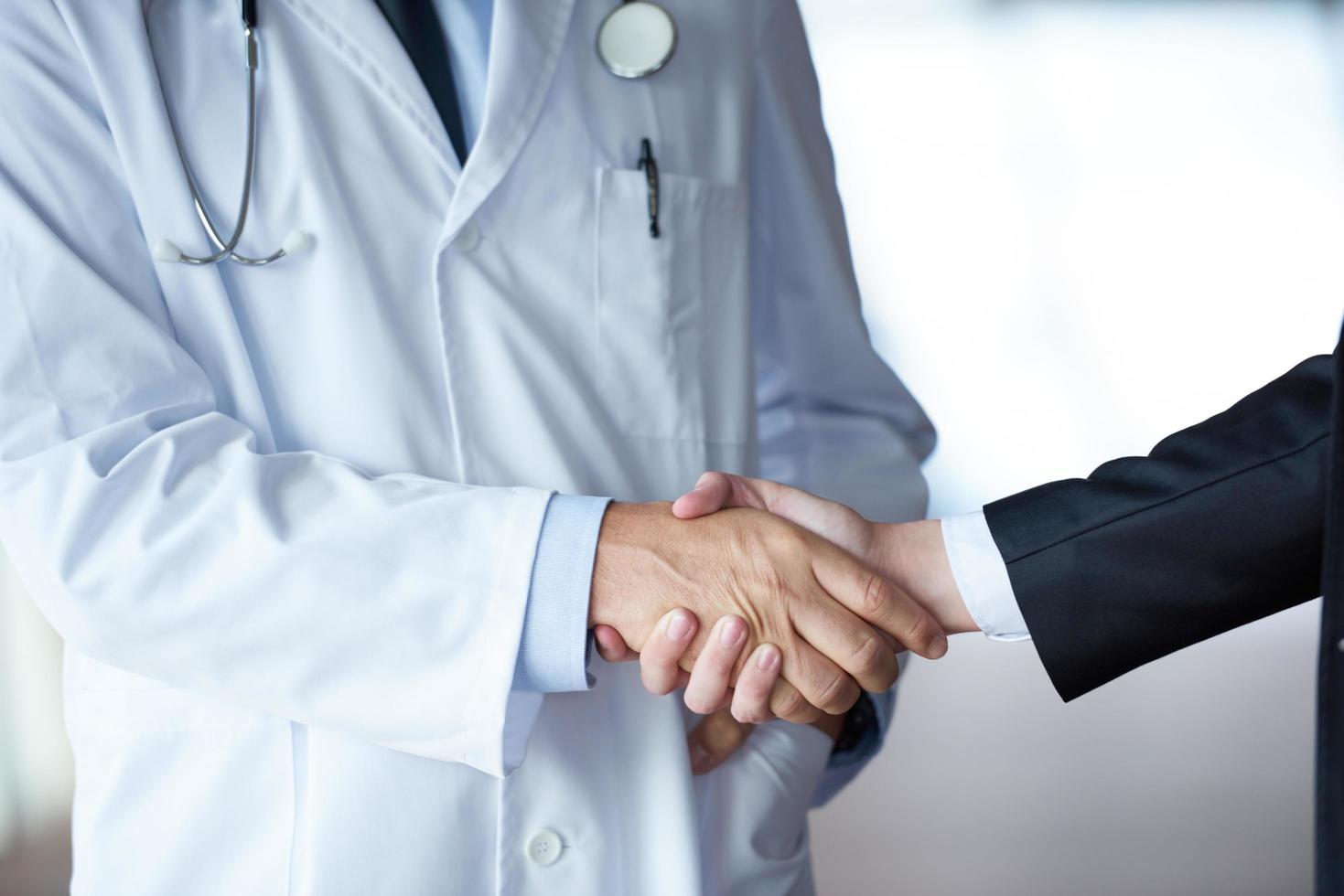 doctor handshake with a patient photo