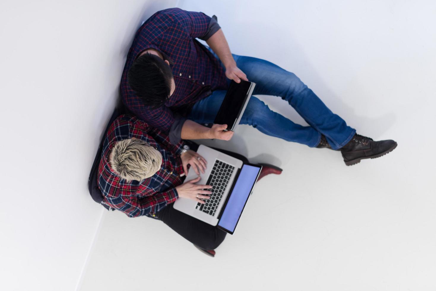 top view of  couple working on laptop computer at startup office photo