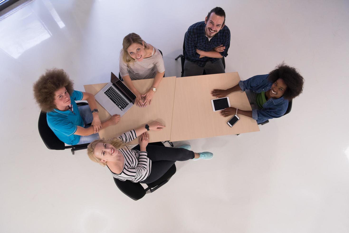 Multiethnic startup business team on meeting  top view photo