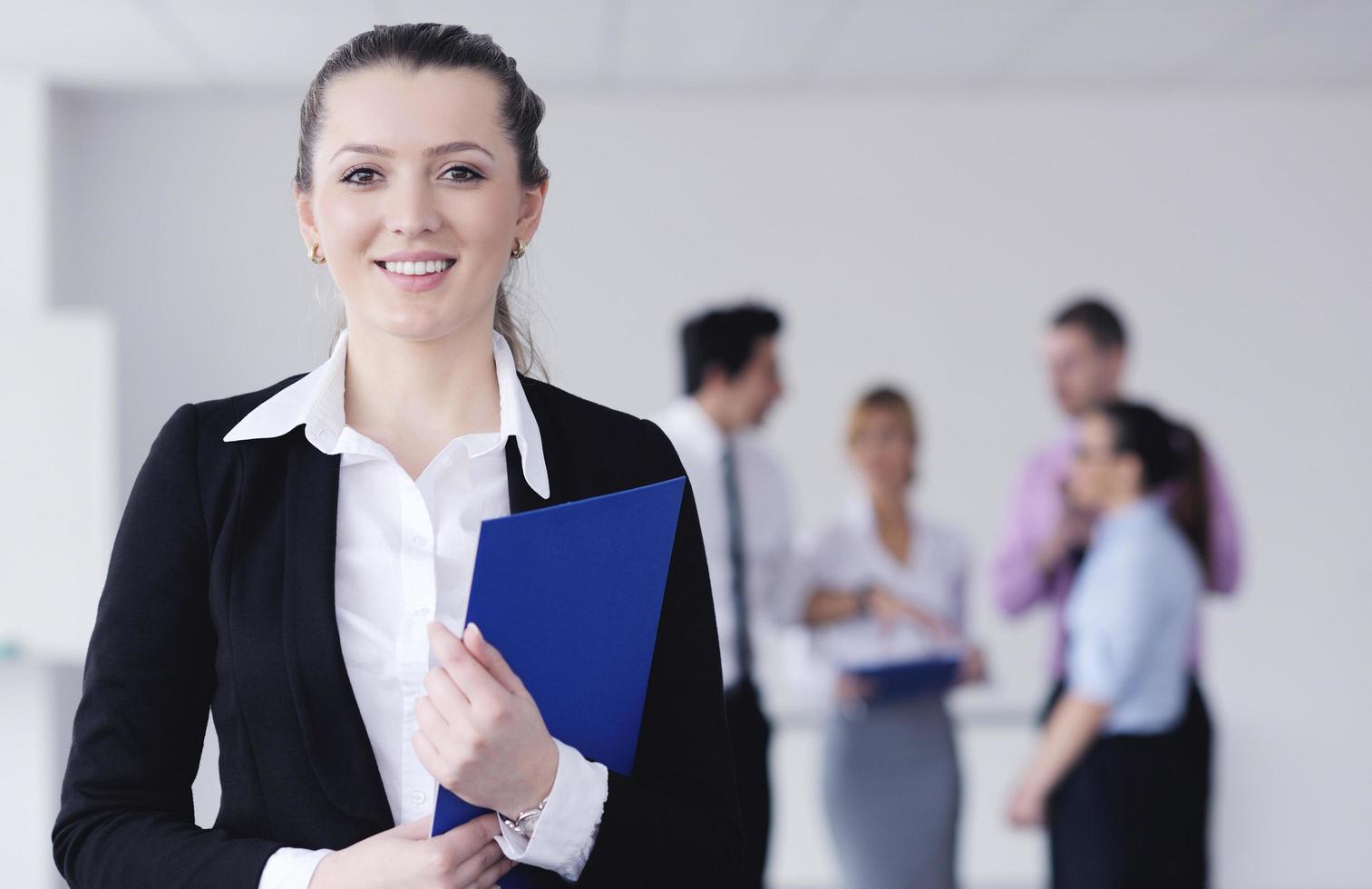 business woman standing with her staff in background photo