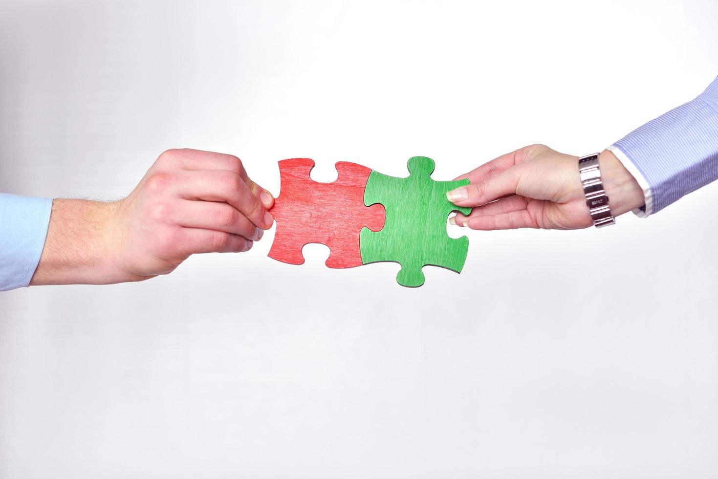 Group of business people assembling jigsaw puzzle photo