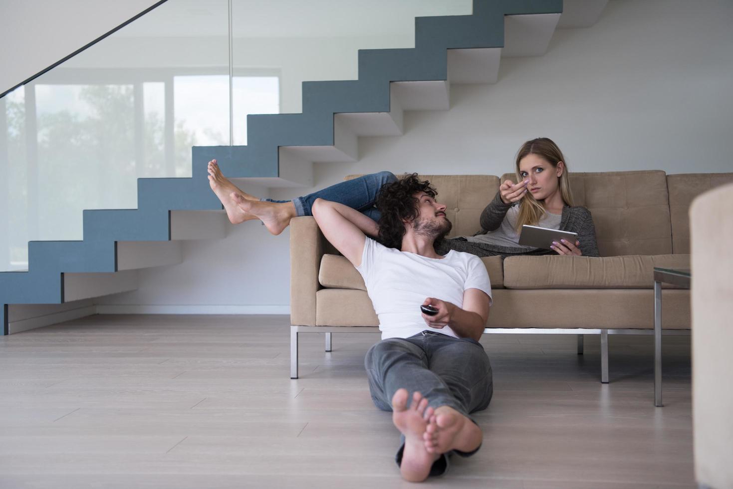 young couple relaxes in the living room photo