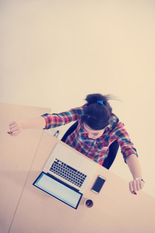 top view of young business woman working on laptop photo