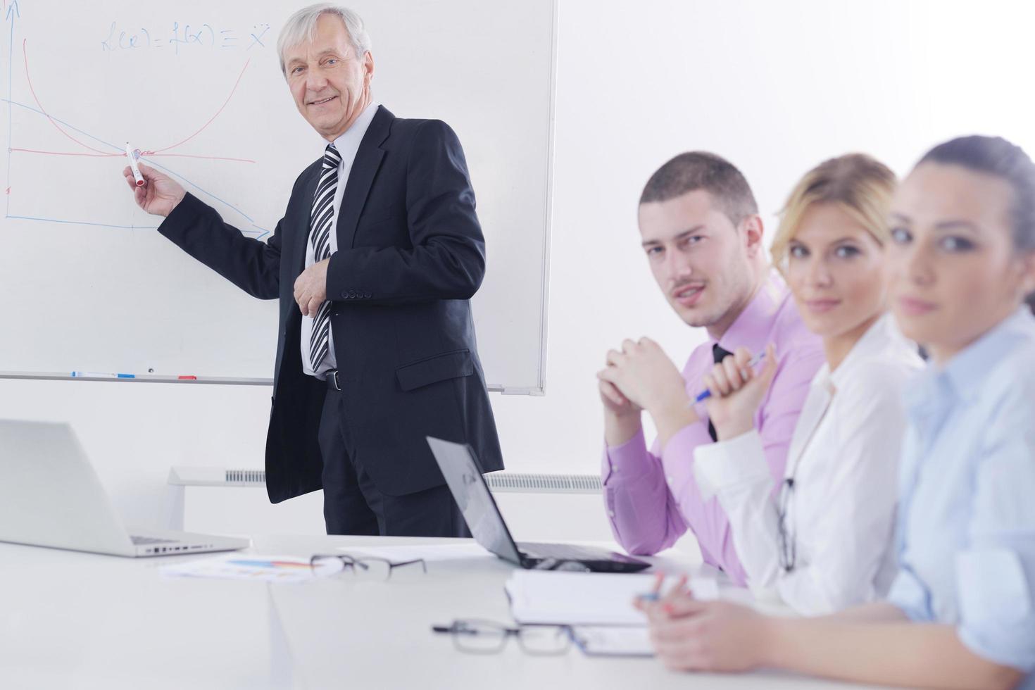 Senior business man giving a presentation photo