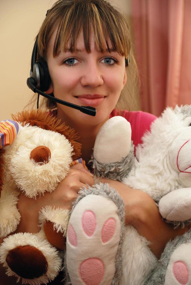 Cute young woman huging toys photo