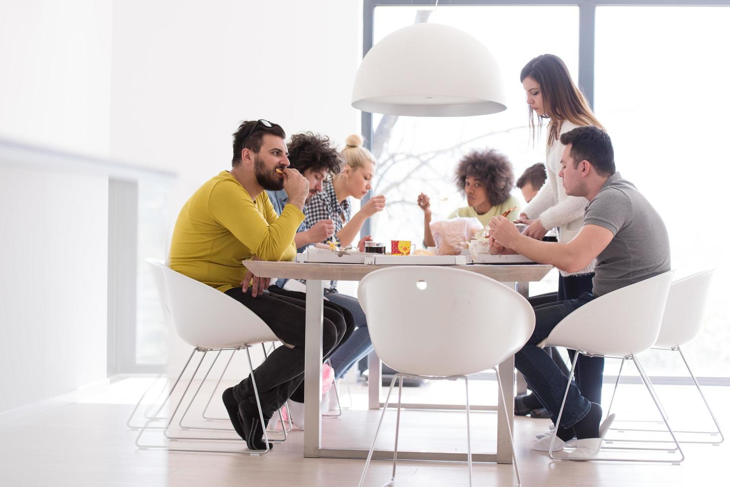 multiethnic group of happy friends lunch time photo