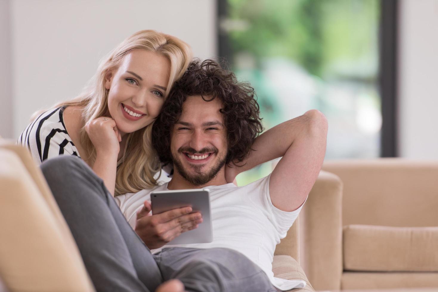 couple relaxing at  home with tablet computers photo