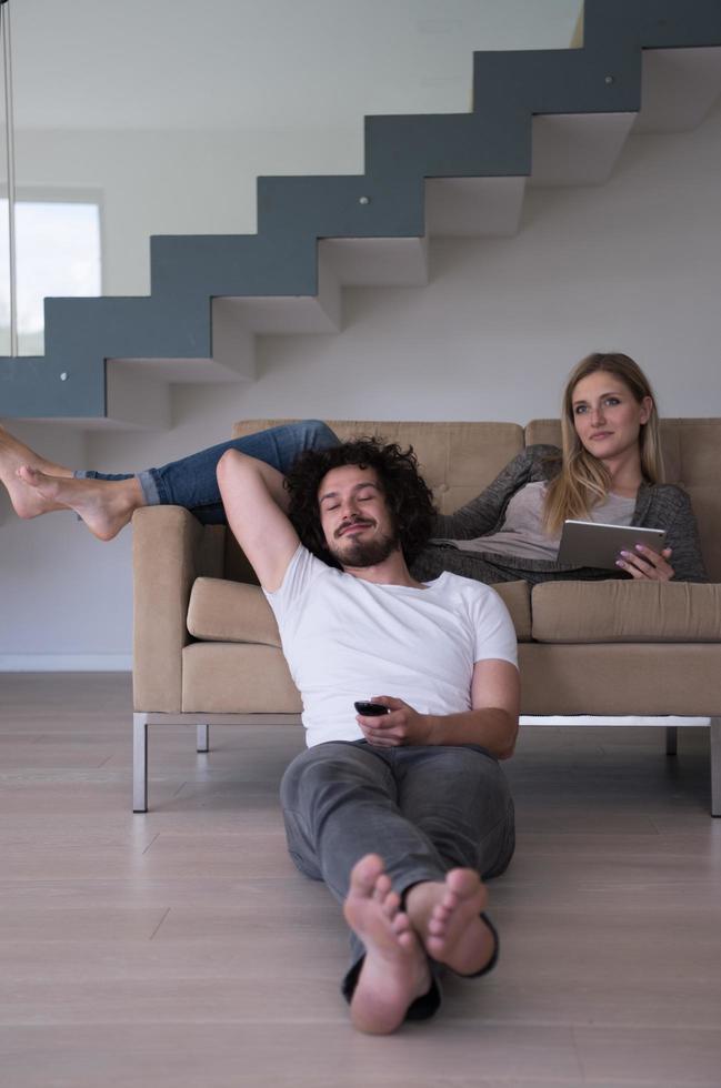 young couple relaxes in the living room photo