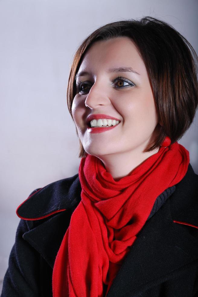 Portrait of a young woman wearing red scarf photo