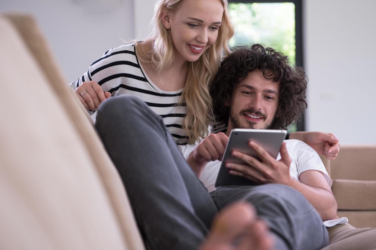 couple relaxing at  home with tablet computers photo