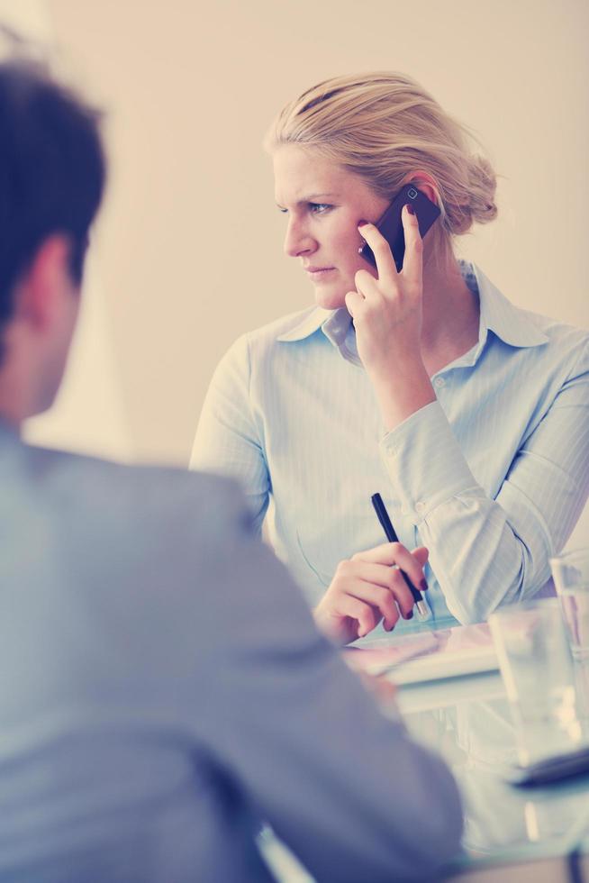 young business woman talk by cellphone on meetng photo