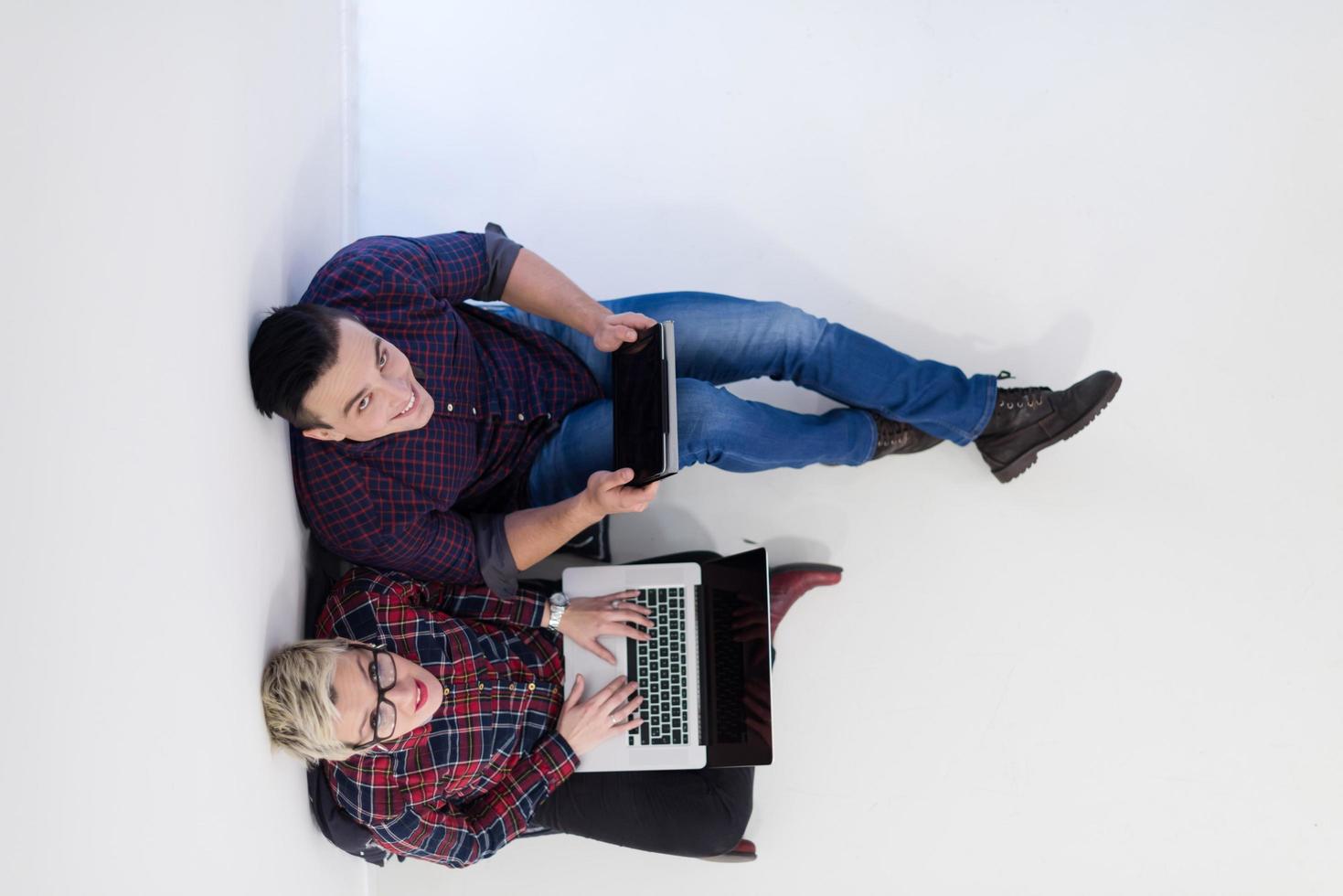 top view of  couple working on laptop computer at startup office photo