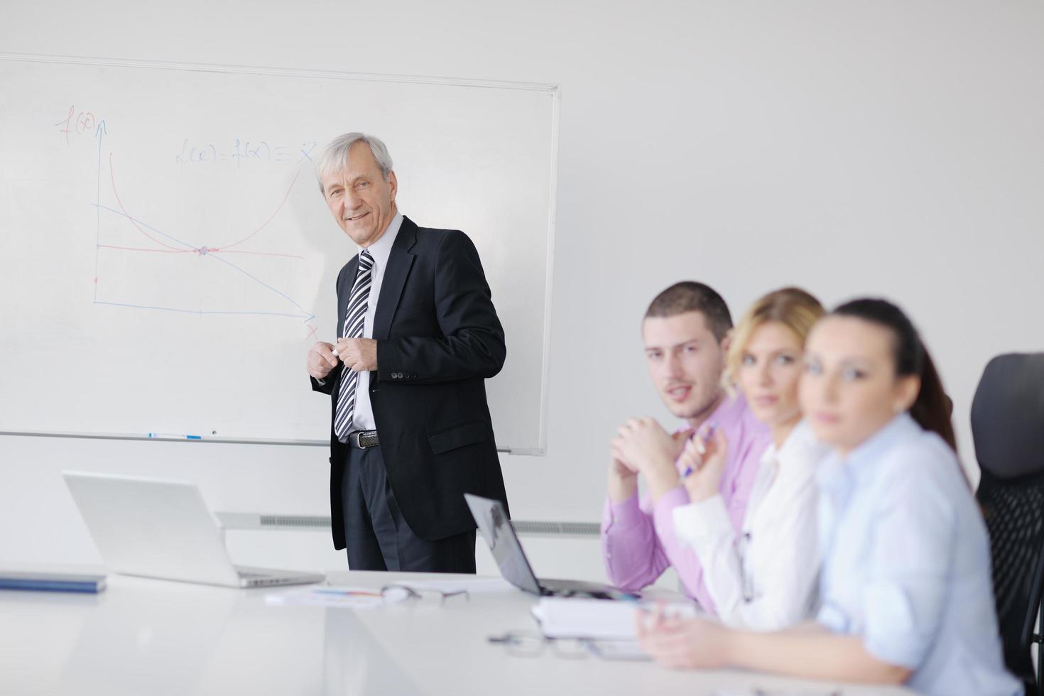 Senior business man giving a presentation photo