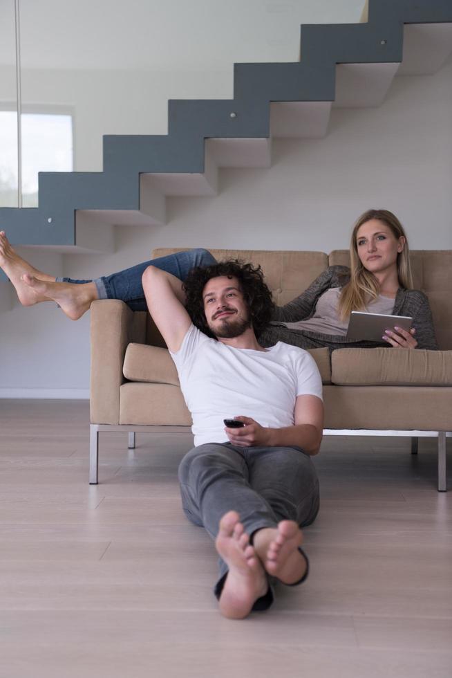 young couple relaxes in the living room photo