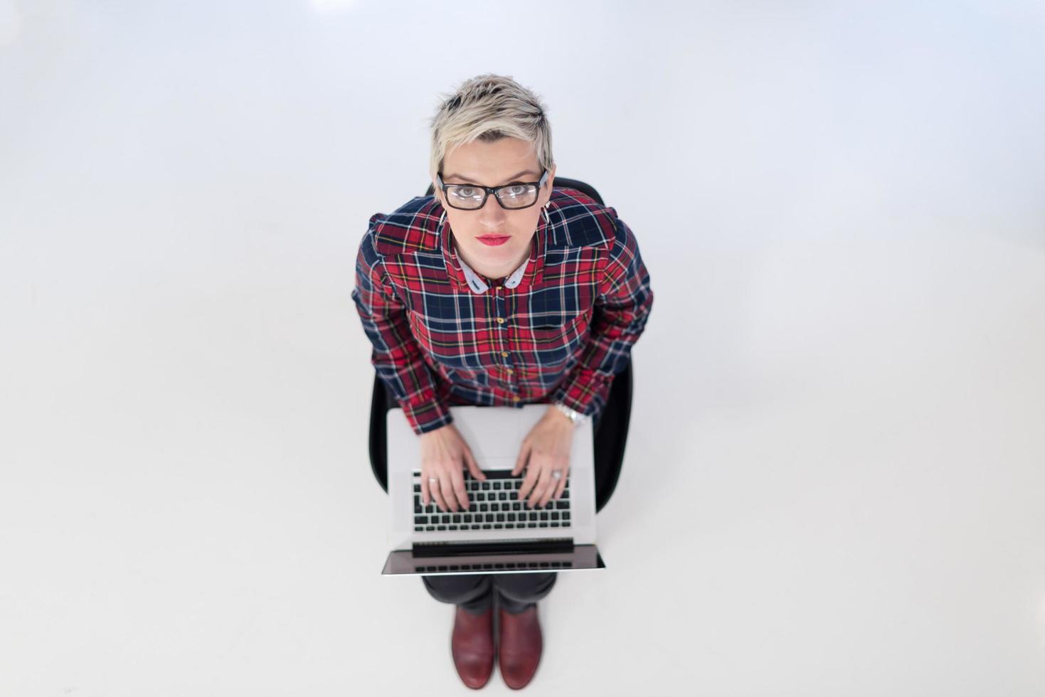 top view of young business woman working on laptop computer photo