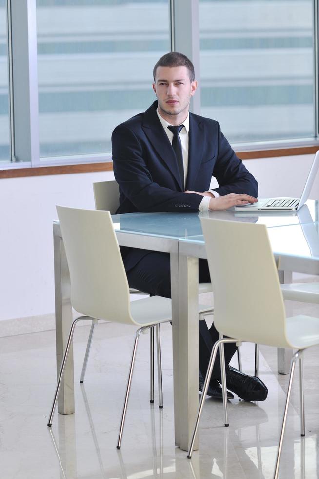 young business man alone in conference room photo