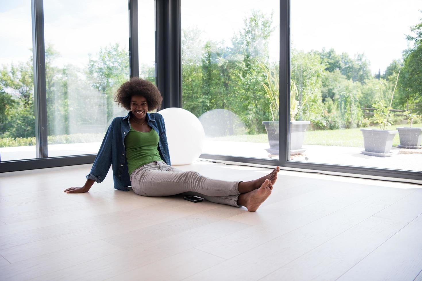 african american  woman  sitting near window photo