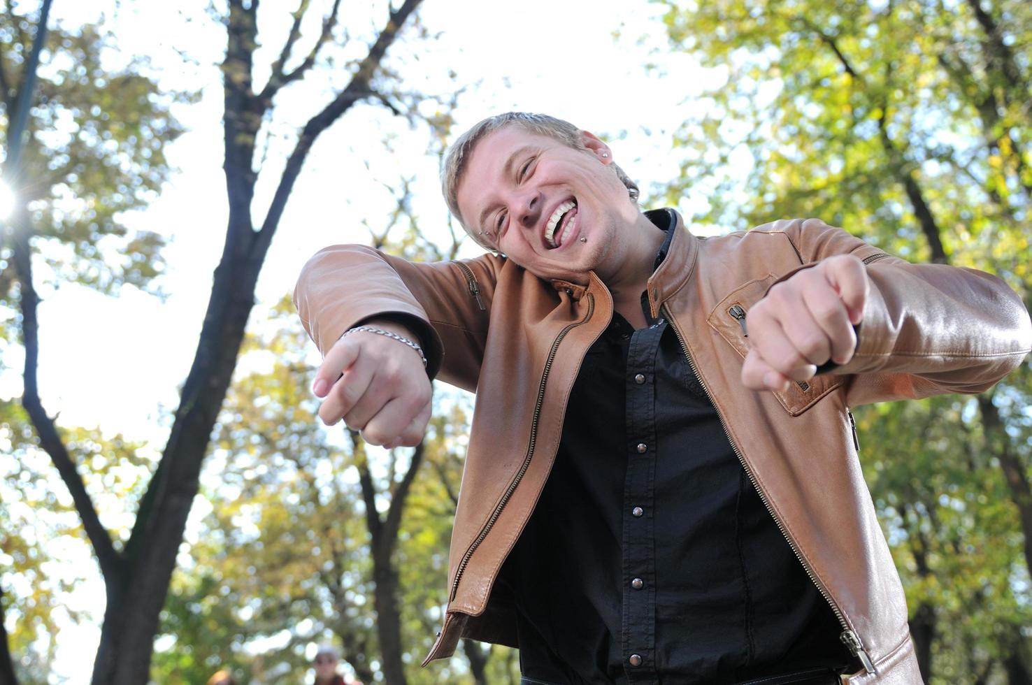 Handsome young man expressing his inner feeling outside in natur photo