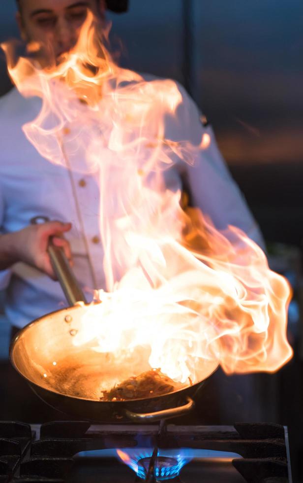 Chef doing flambe on food photo