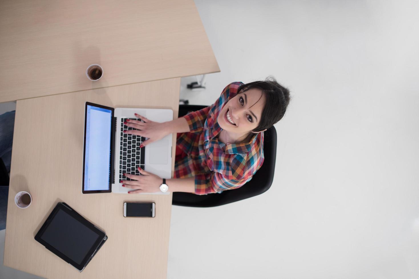 top view of young business woman working on laptop photo
