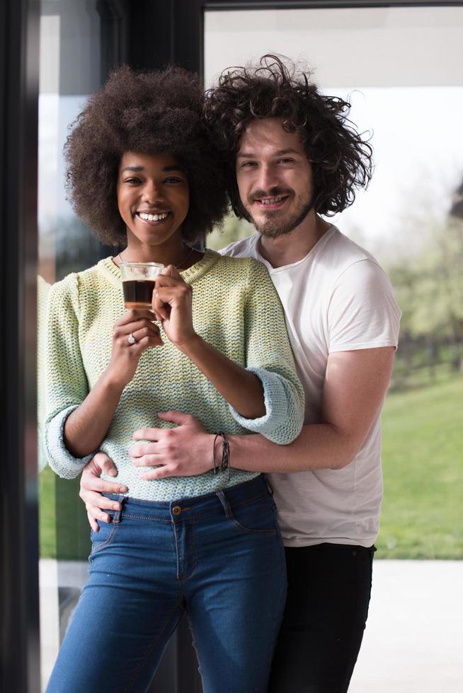 happy multiethnic couple relaxing at modern home indoors photo