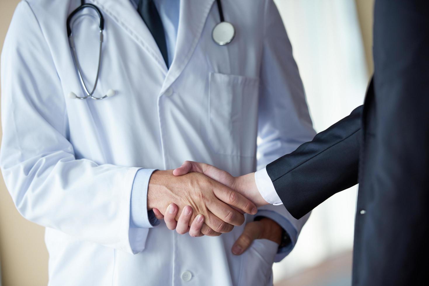 doctor handshake with a patient photo