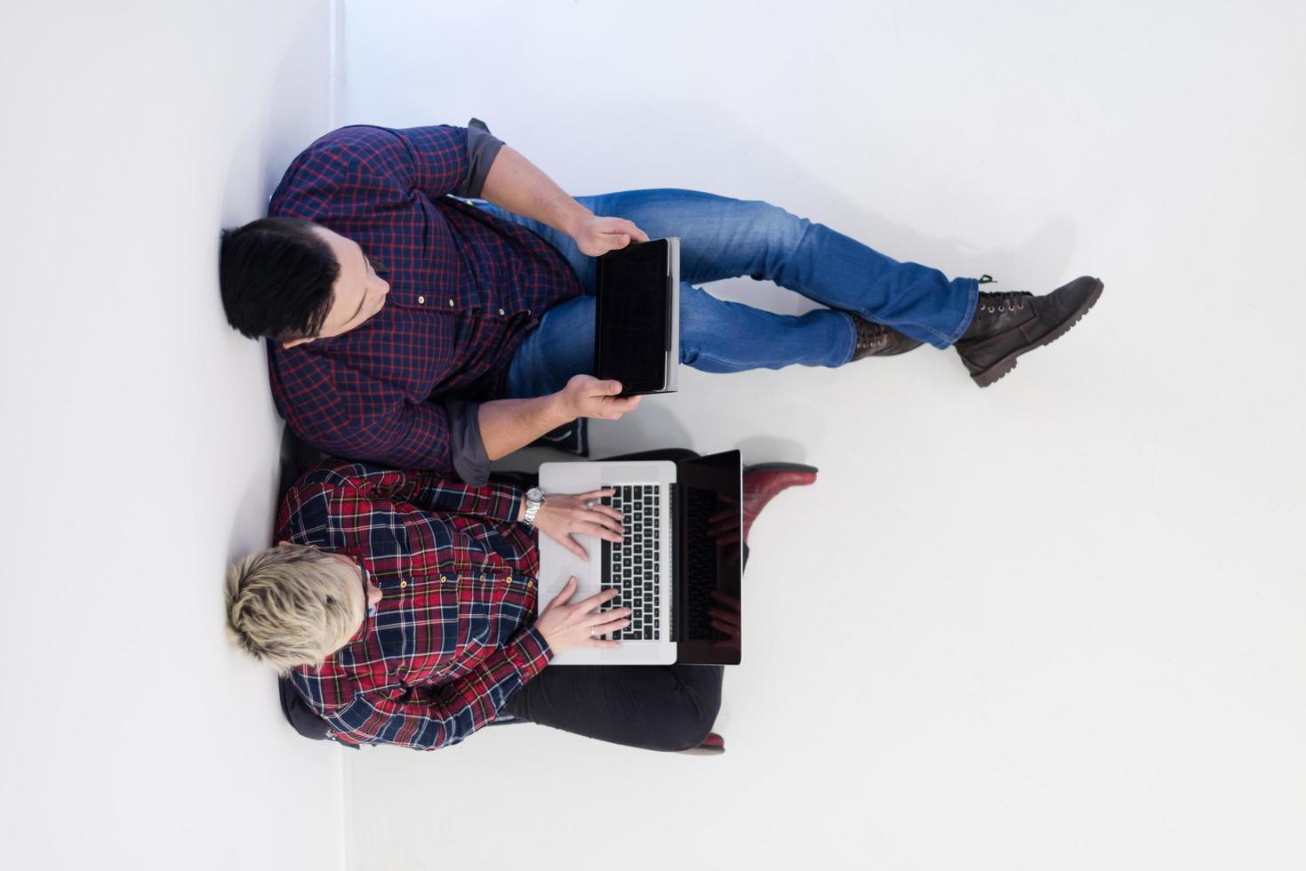 top view of  couple working on laptop computer at startup office photo