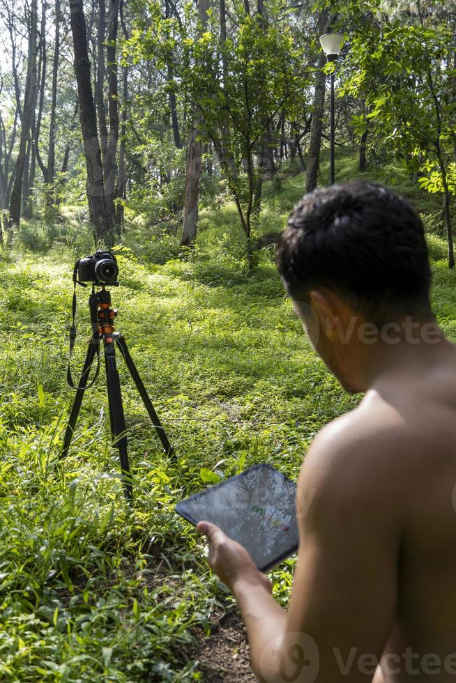 young man explaining drawing on his tablet, while teaching chakra, yoga and meditation class, mexico photo