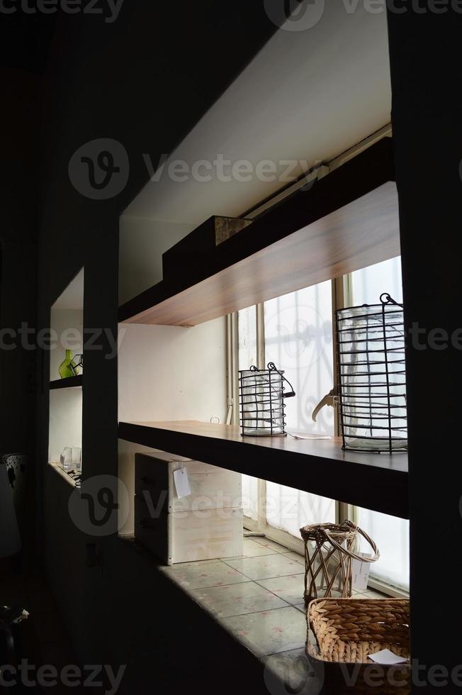 wooden shelves against the light, with decorative objects on the shelves. photo