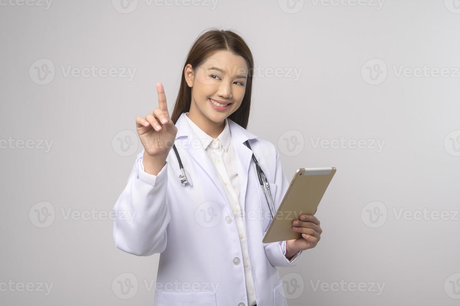 Portrait of female confident doctor over white background studio, healthcare and Medical technology concept. photo