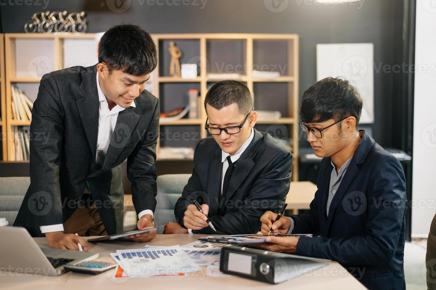 Group of young  business people discussing business plan at modern startup in creative business discussing work modern office building photo
