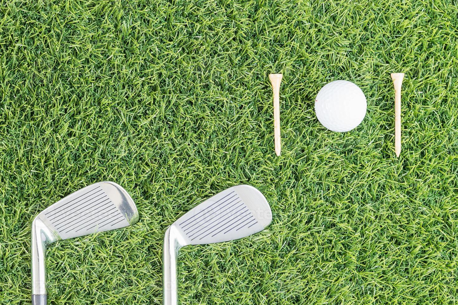 Golf club and Golf ball on green grass photo