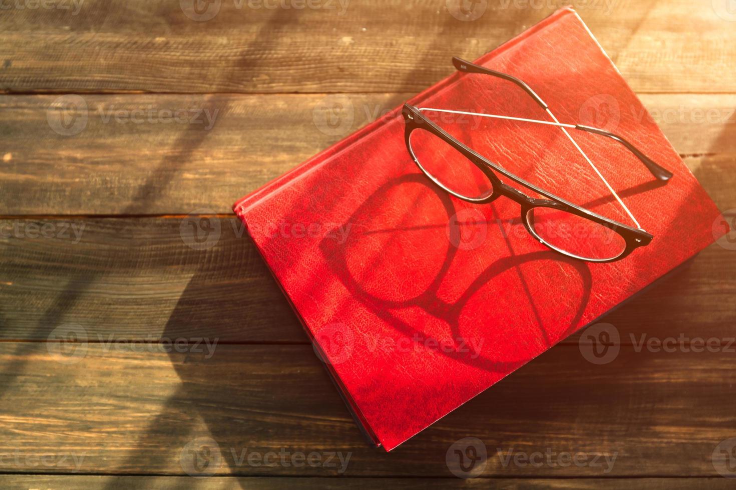 Reading glasses put on hardcover books photo