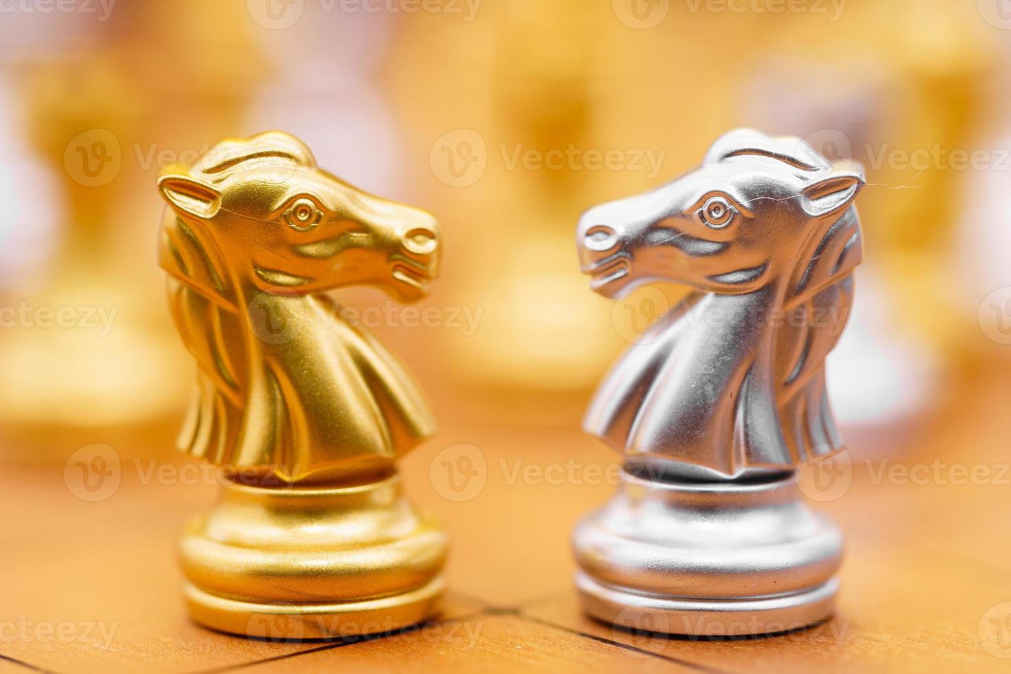 Gold and siver horse on chessboard photo