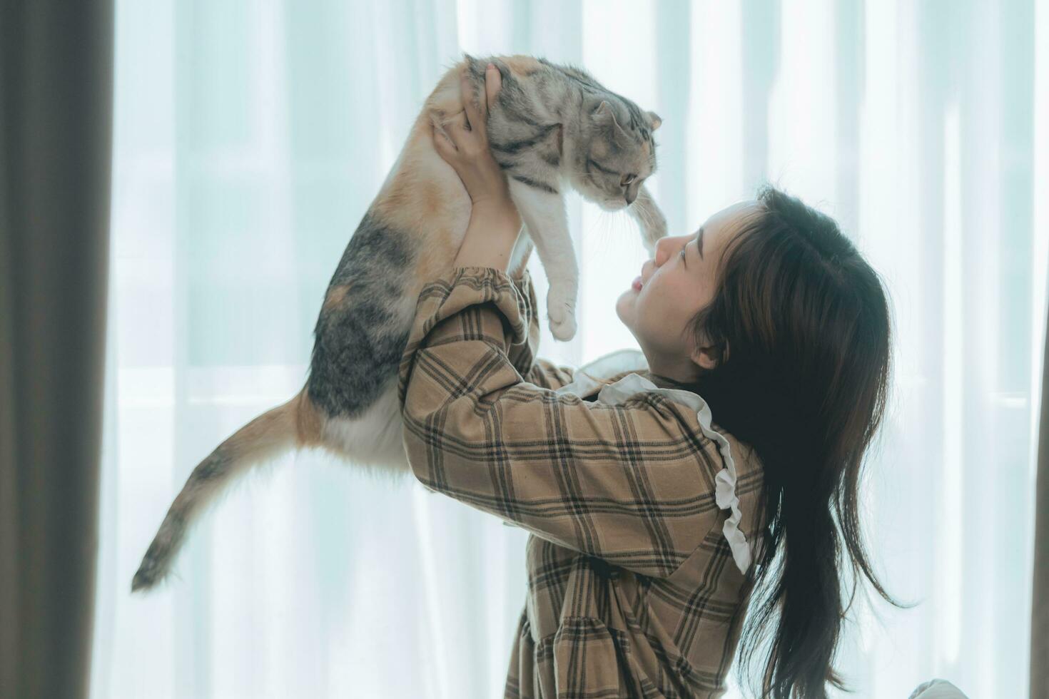 Closeup portrait handsome young  woman, hugs his good friend ginger cat on white wall background. Positive human emotions, facial expression, feelings. People and animals in love photo