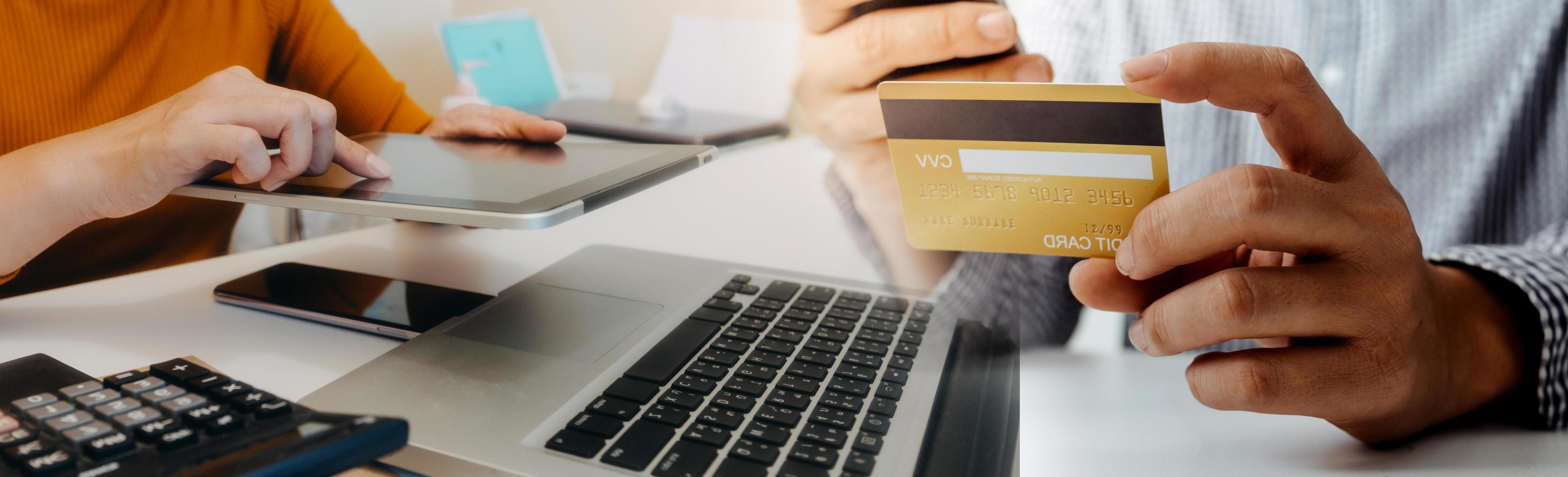 technology, people and online shopping concept - happy smiling man with tablet pc computer and credit card at home photo