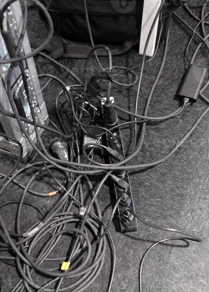 Chaotic cables lying on the floor photo
