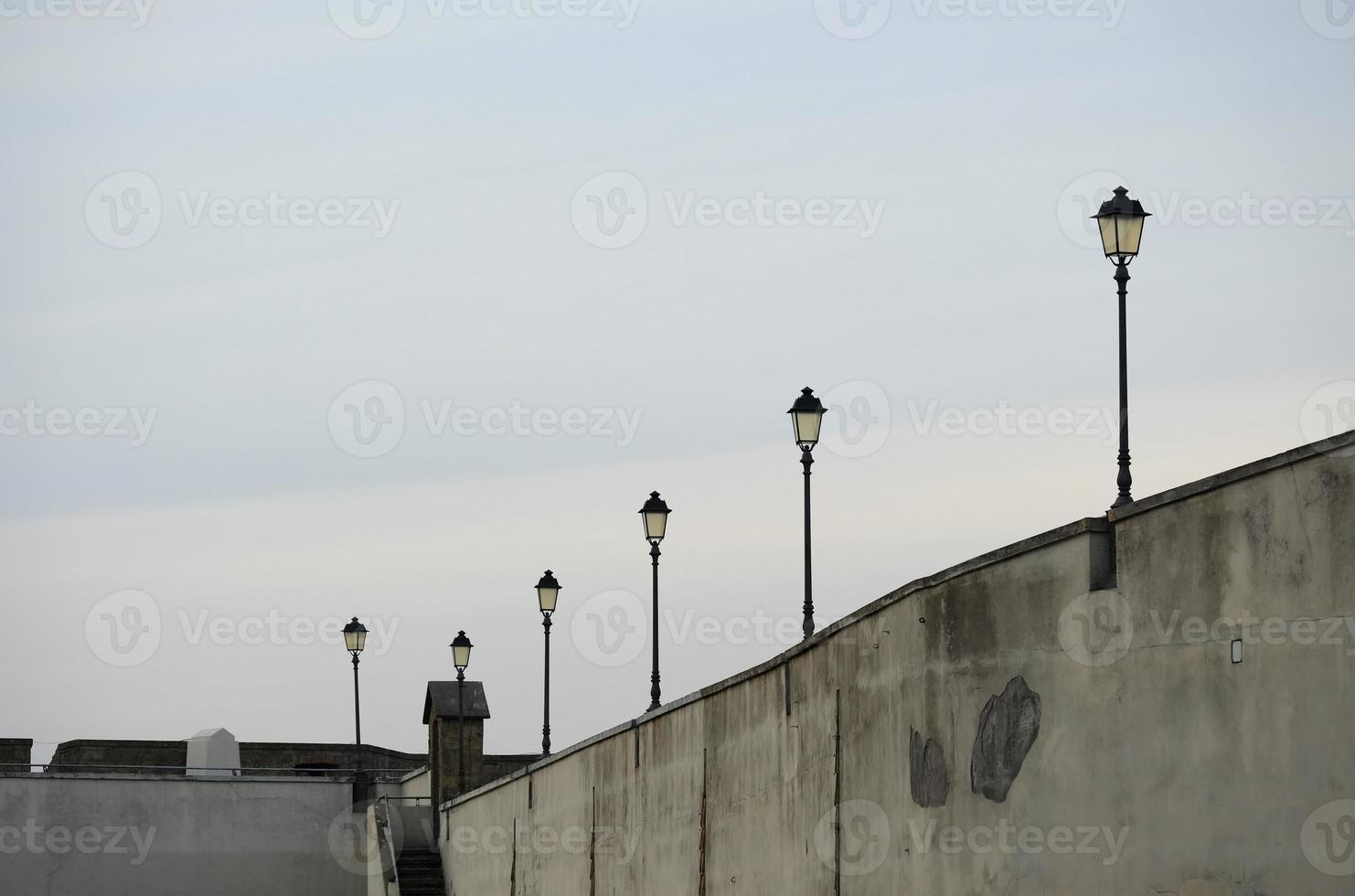 Row of lamp posts on Castle Sant Elmo in Naples, Italy photo