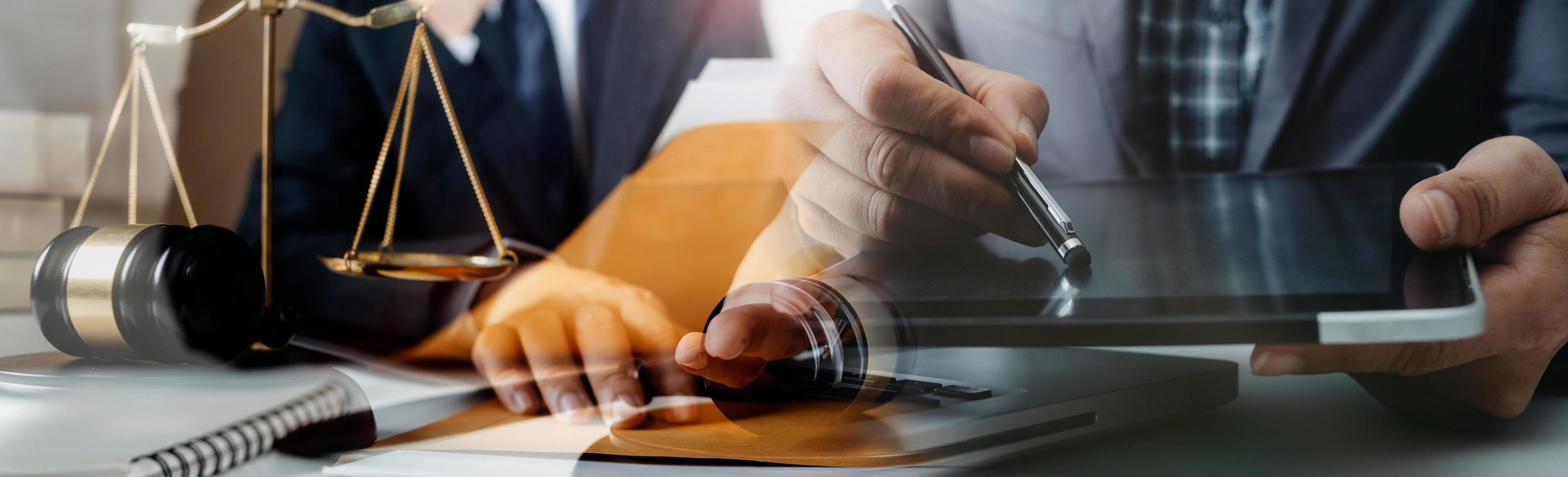 Business and lawyers discussing contract papers with brass scale on desk in office. Law, legal services, advice, justice and law concept picture with film grain effect photo