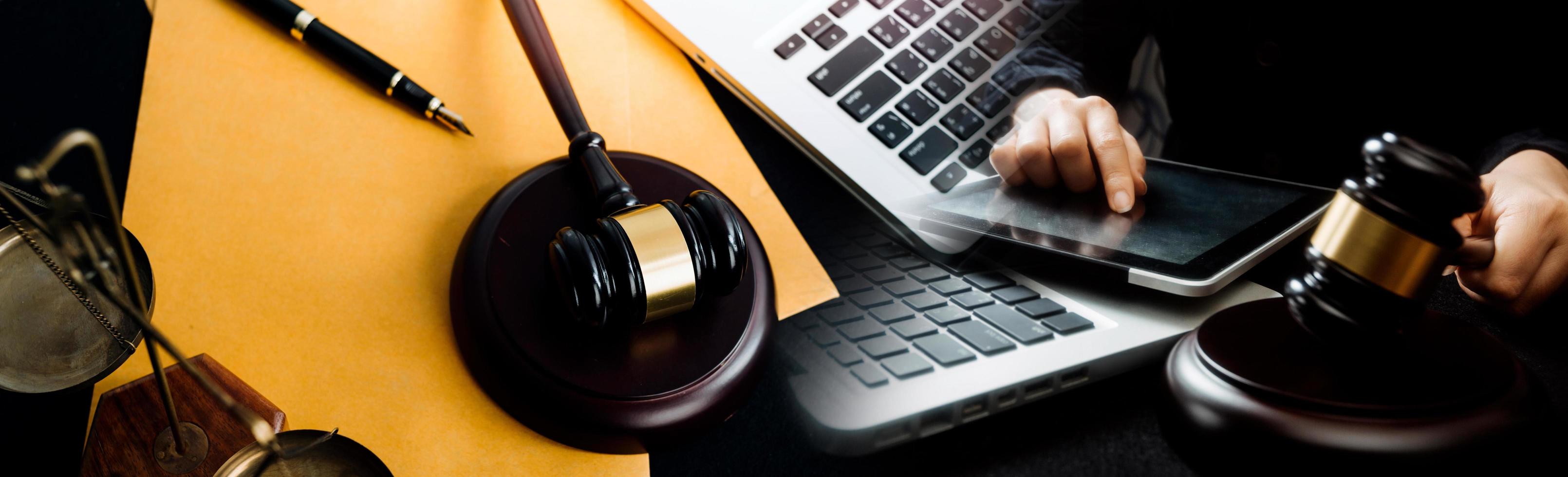 Business and lawyers discussing contract papers with brass scale on desk in office. Law, legal services, advice, justice and law concept picture with film grain effect photo