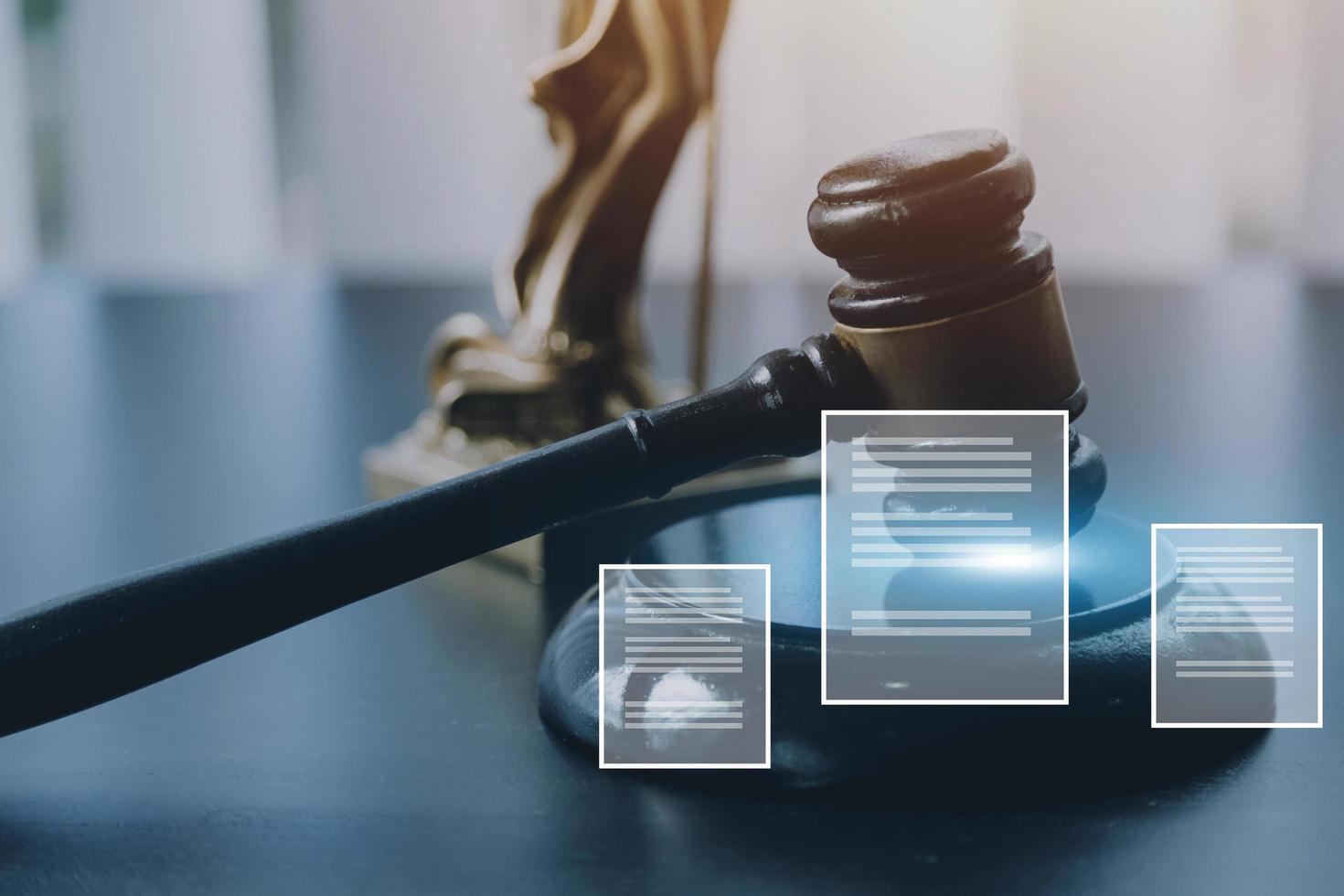 Justice and law concept.Male judge in a courtroom with the gavel, working with, computer and docking keyboard, eyeglasses, on table in morning light photo