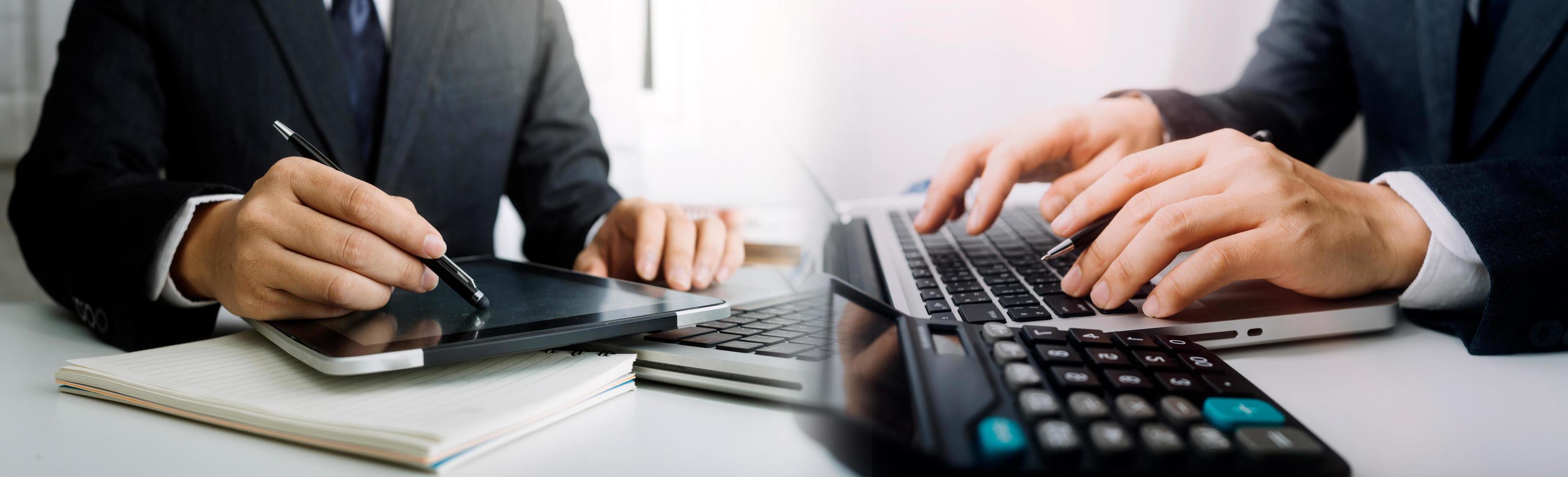 Business accounting concept, Business man using calculator with computer laptop, budget and loan paper in office. photo