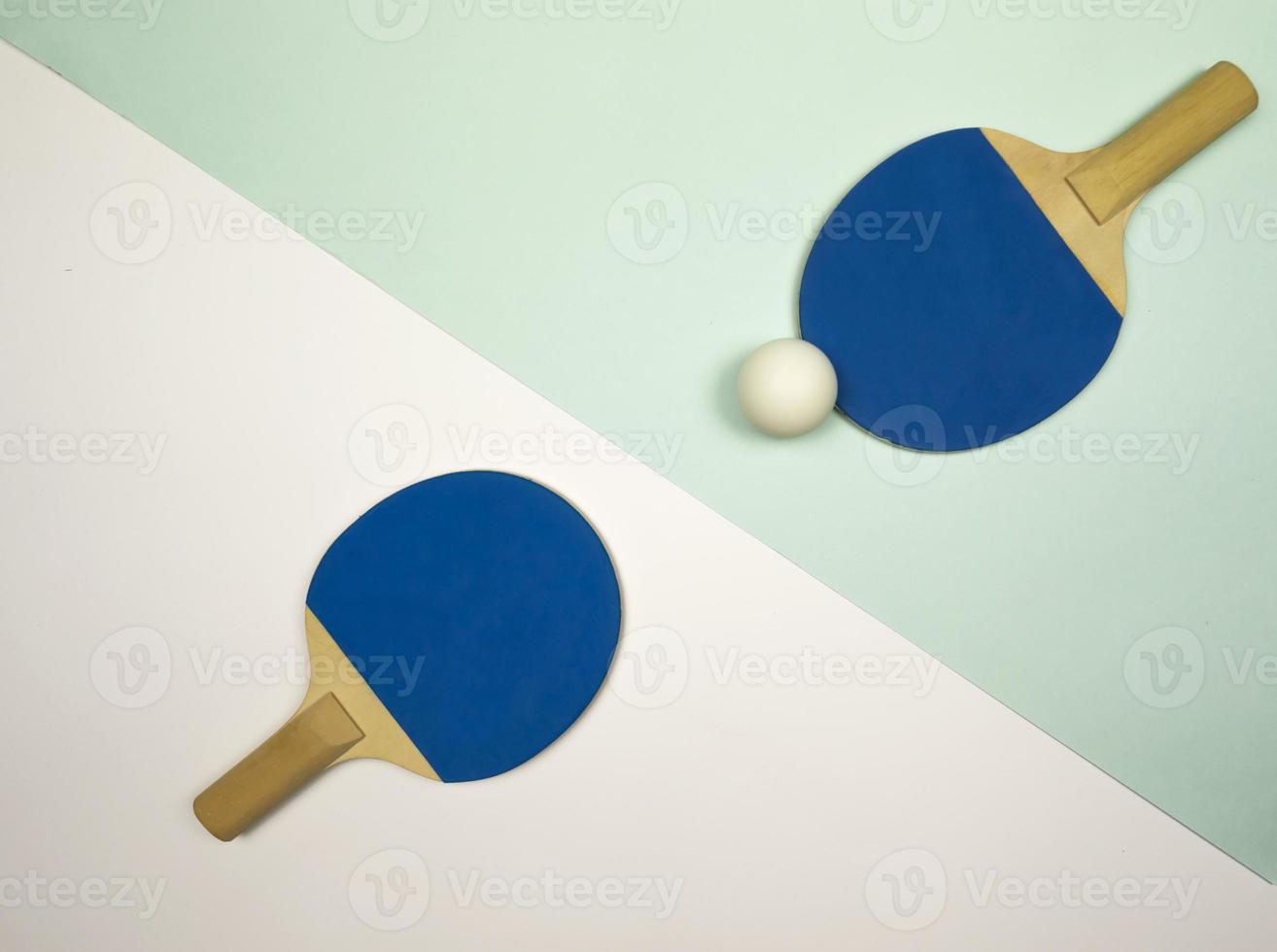 Table tennis rackets lying on a colorful background ready for the competitions photo