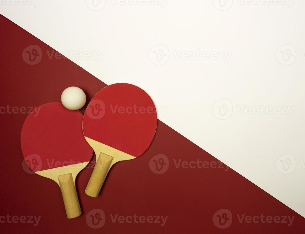 Table tennis rackets lying on a colorful background ready for the competitions photo