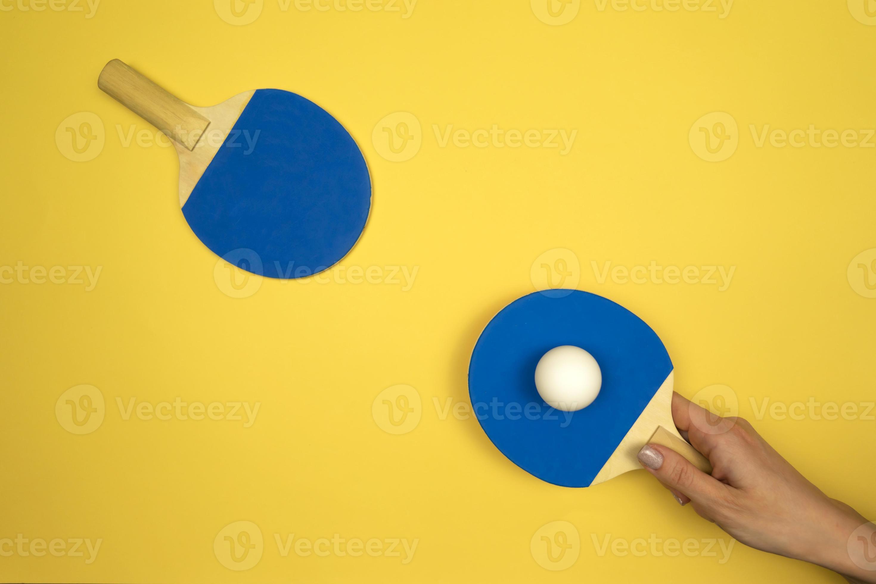 Table tennis rackets lying on a colorful background ready for the