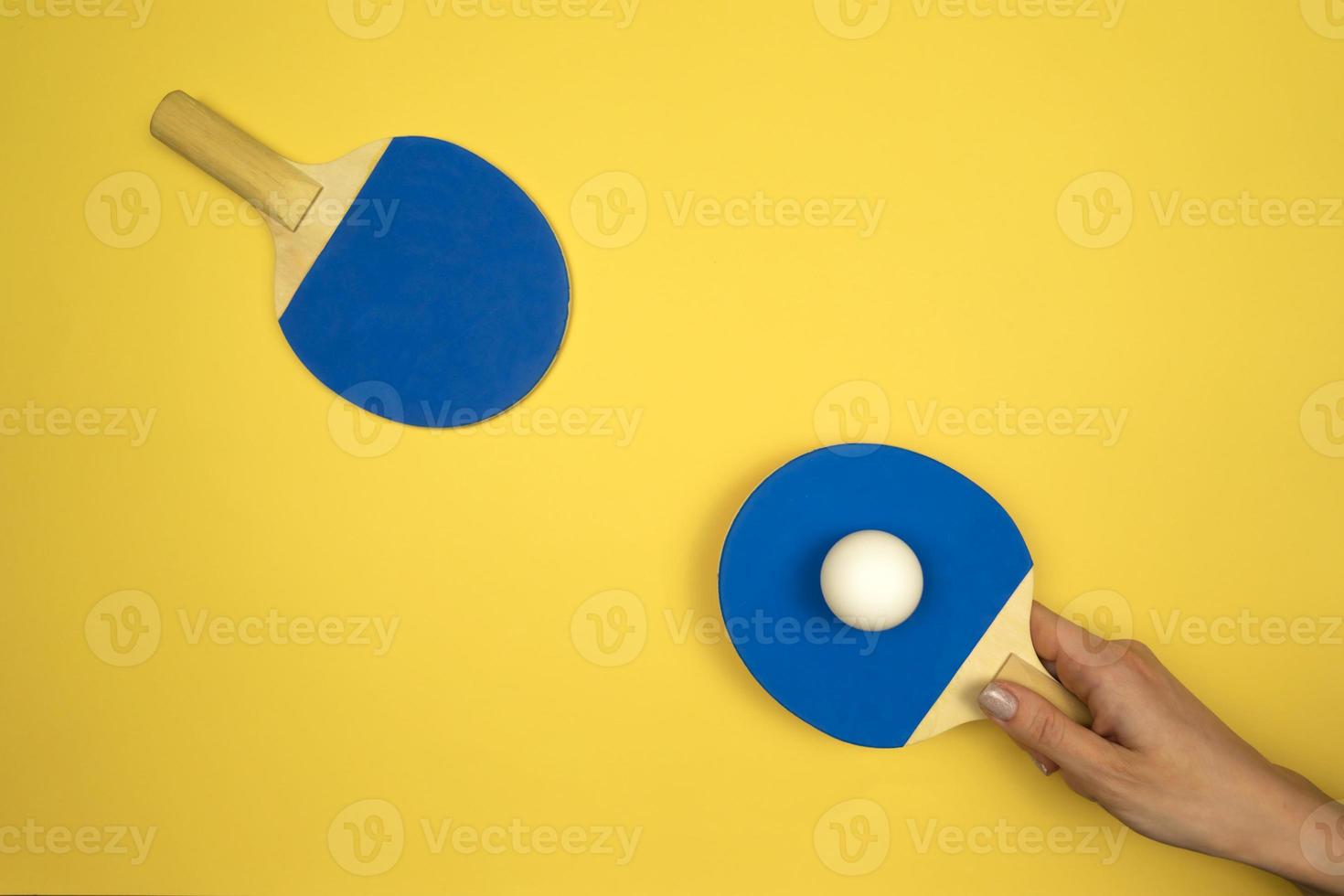 Table tennis rackets lying on a colorful background ready for the competitions photo