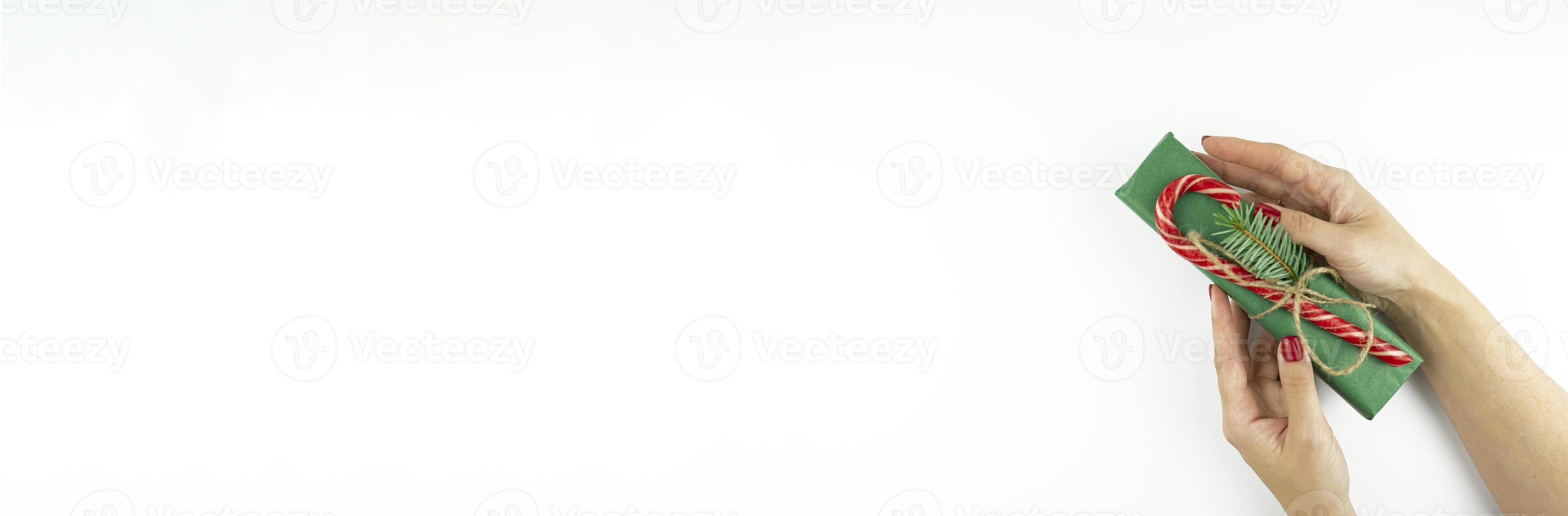 A festive banner of a woman holding a present for Christmas holidays photo